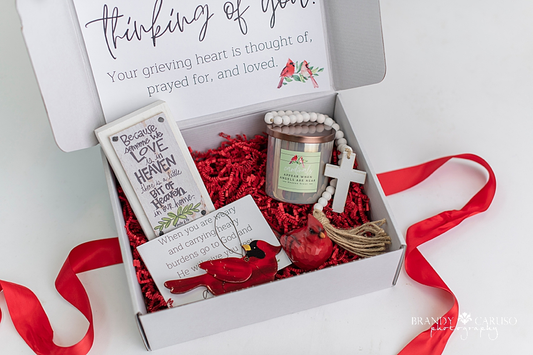 Cardinal themed gift box that includes a Cardinal quote candle, a cross, a Cardinal ornament and a table top quote 