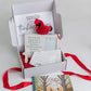 A gift box with assorted Cardinal themed sympathy gifts 