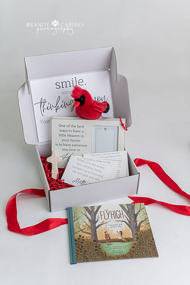 A gift box with assorted Cardinal themed sympathy gifts 