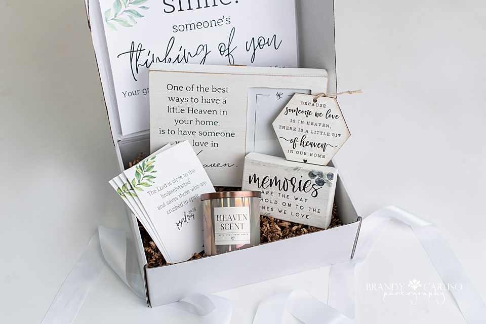 A sympathy gift box of goods for the bereaved heart. Includes a candle, a picture frame, ornament and quote to help anyone who is experiencing loss