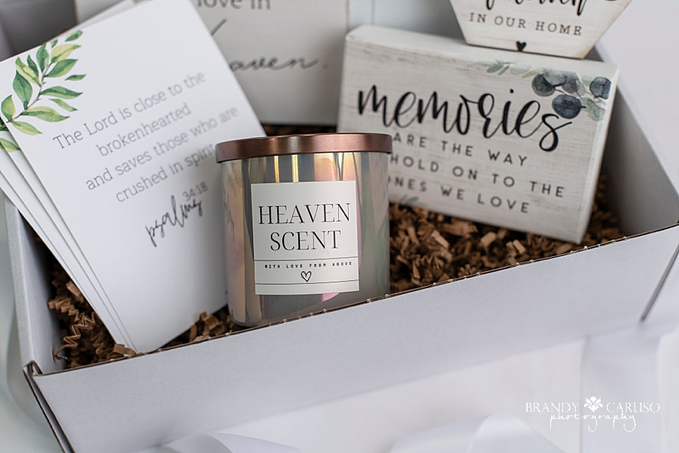 A sympathy gift box of goods for the bereaved heart. Includes a candle, a picture frame, ornament and quote to help anyone who is experiencing loss